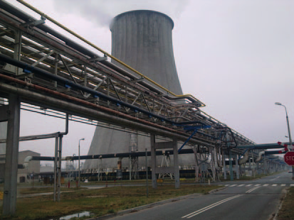 Large industrial pipe rack near a cooling tower